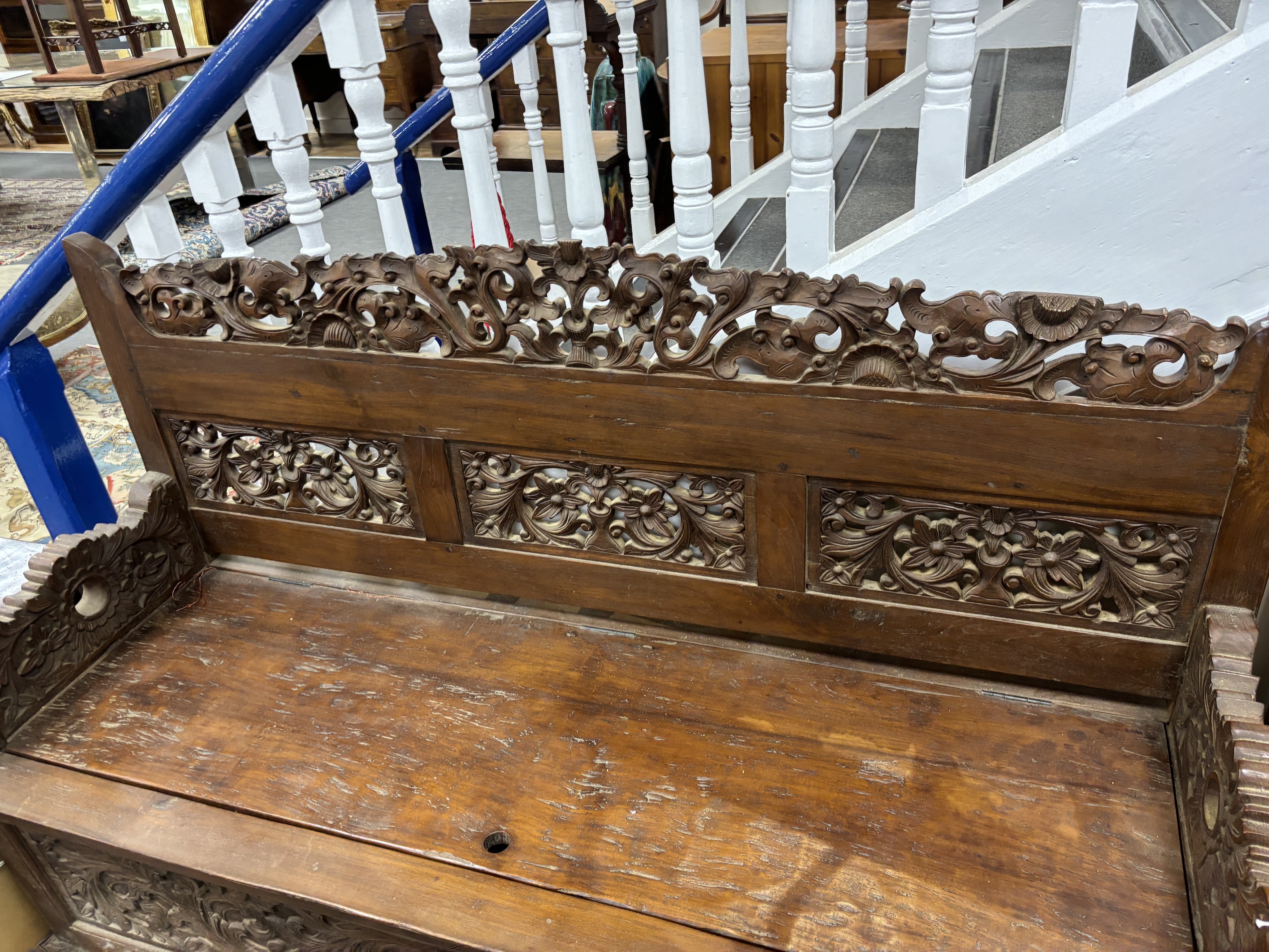 An Indonesian carved hardwood box seat settle, width 56cm, depth 56cm, height 98cm
